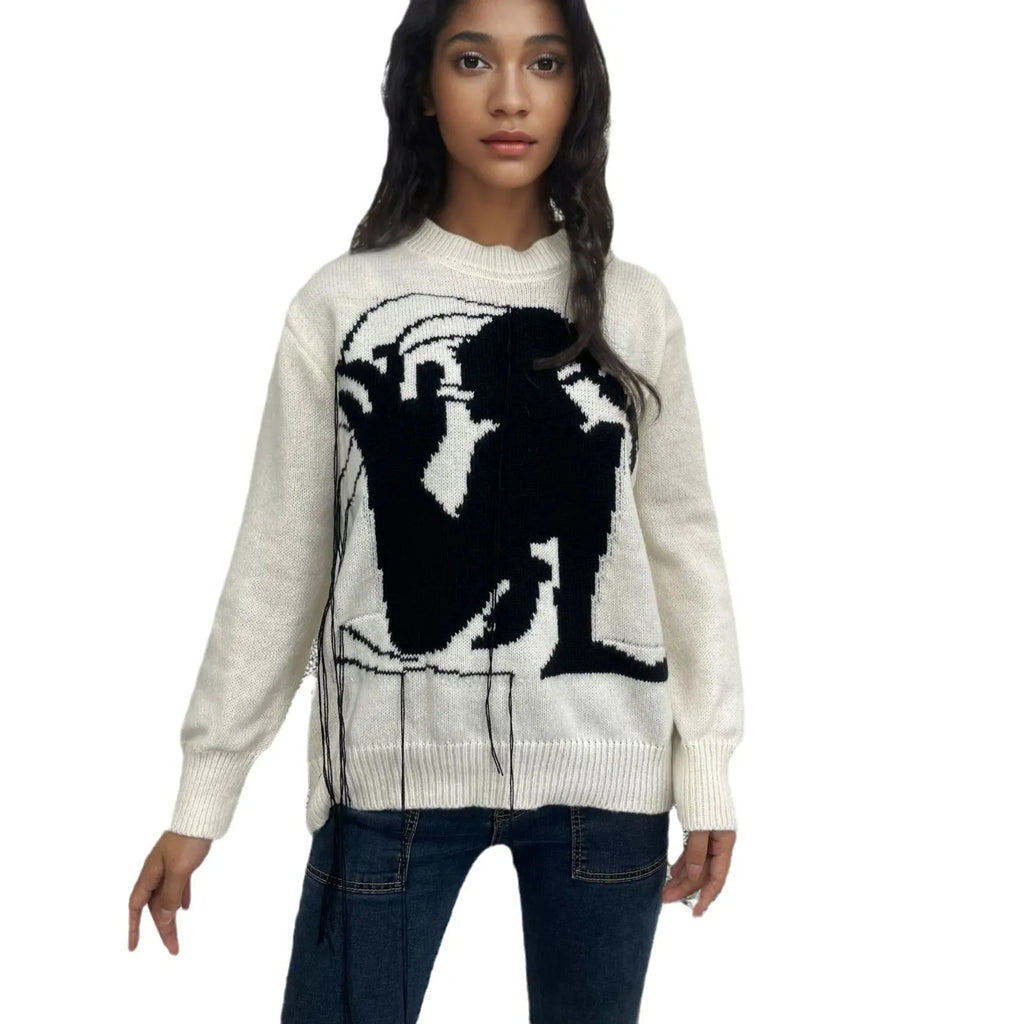 Grey loose women's alpaca wool pullover sweater with tassel detail on a hanger.