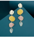 A pair of simple disc-shaped earrings with a morandi three-colour oil-drip finish and sterling silver posts.
