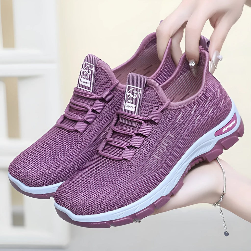 Men's and women's low-top casual sneakers with soft PVC sole in black, brown, grey, light purple, and red.