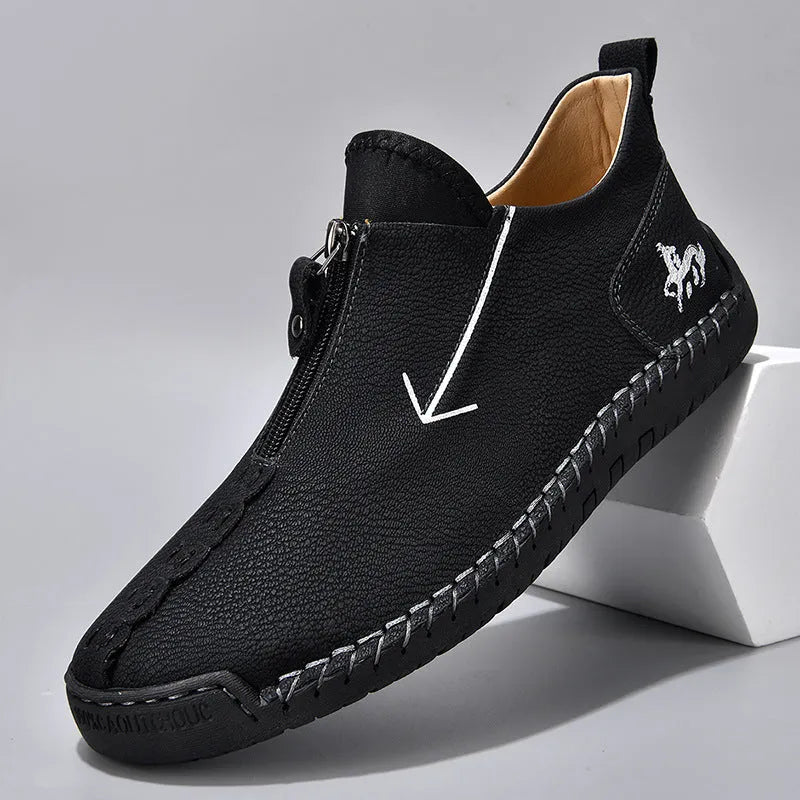 Men's black casual leather boots with a front side zipper and a hand-stitched rubber sole.
