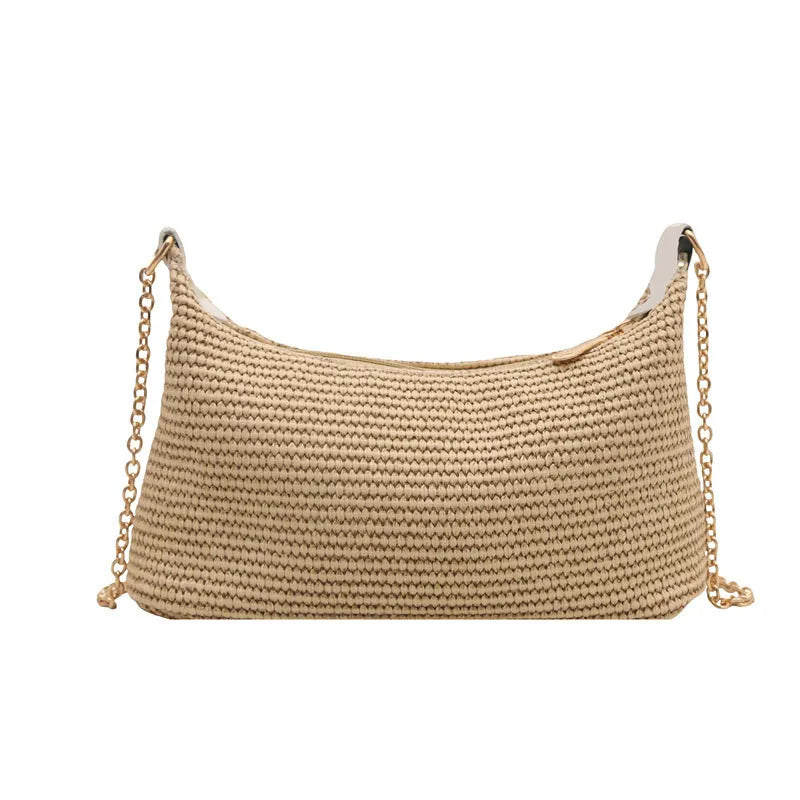 Khaki woven straw crossbody handbag with square shape and crossbody strap.