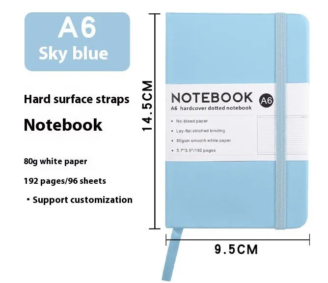 A5 and A6 size notebooks with soft skin-feel PU leather covers and a strap, shown in various colours next to open pages with horizontal ruled lines.