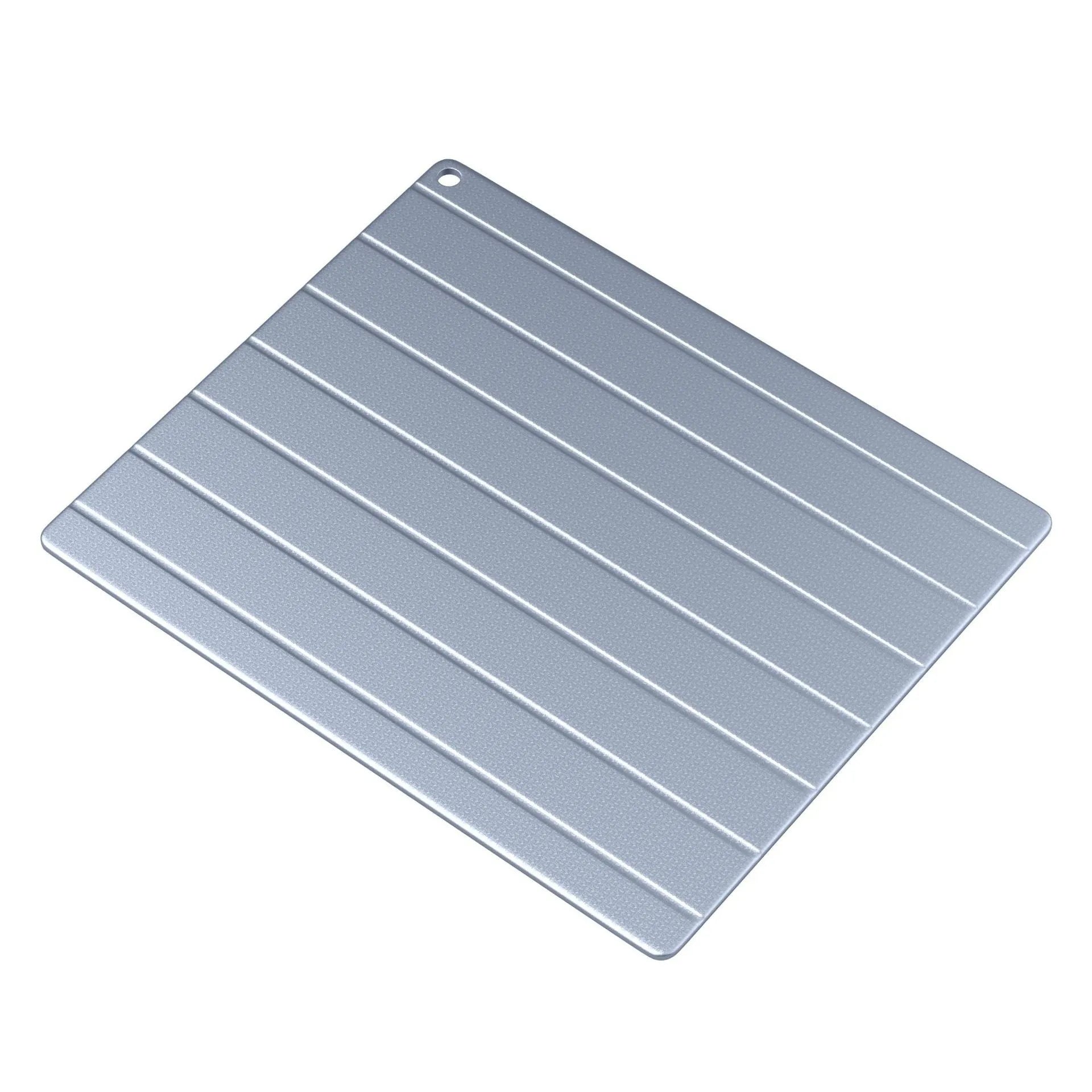 Modern aluminium kitchen defrosting plate on a countertop, shown next to frozen food.