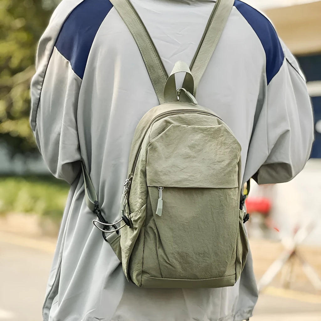 Waterproof nylon backpack in black, green, grey, or white, free size, crossbody or chest bag for outdoor travel.