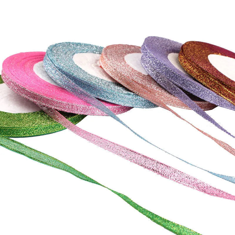 Roll of narrow 0.6cm wide polyester gift ribbon in a choice of colours including metallic gold and silver.