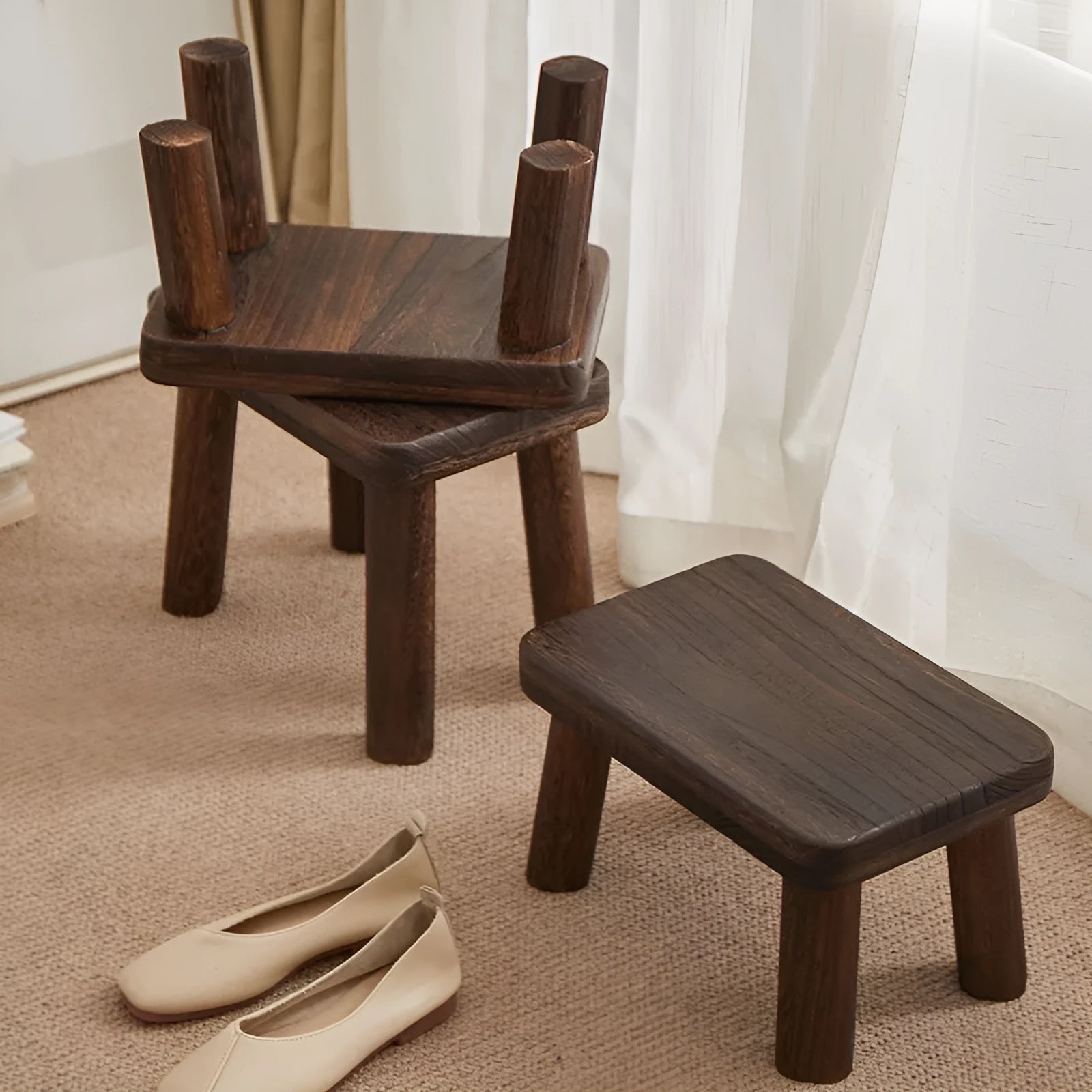 Solid wood household stool with distressed finish, shown as a changing stool or footrest.