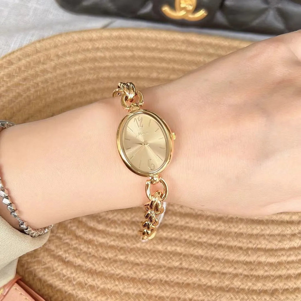 Ladies steel strap watch with oval hollow chain, silver case, white face, casual style