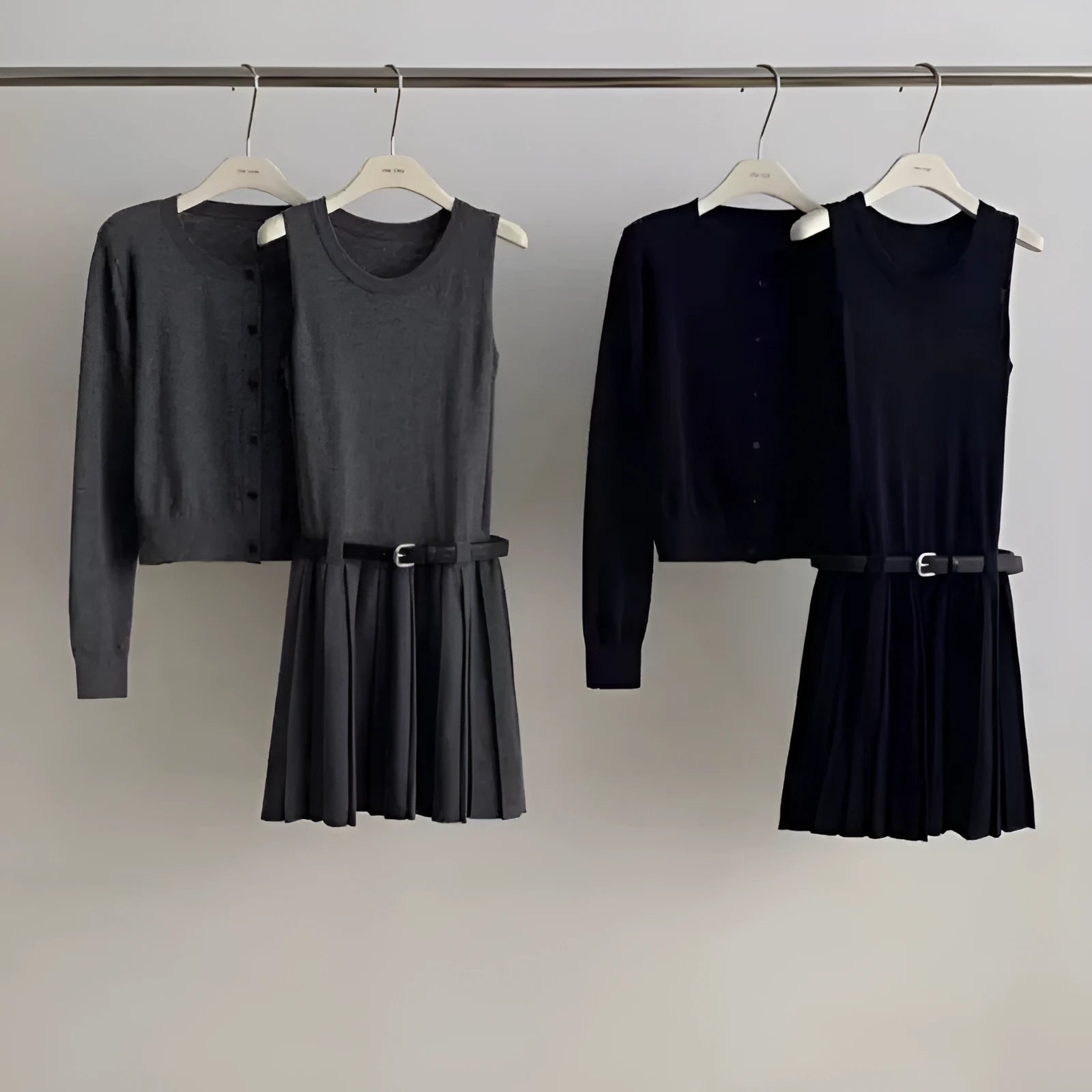 Grey knitted two-piece set with 3D pattern, featuring a belted vest skirt and long-sleeve cardigan.