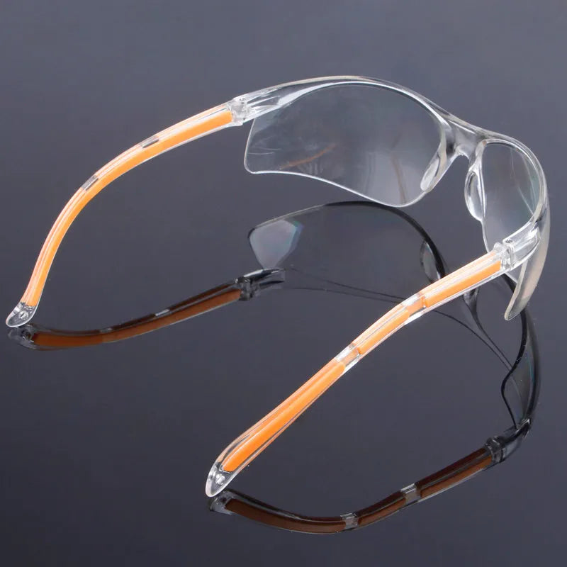 Transparent polycarbonate safety goggles with yellow frame for industrial and lab eye protection.