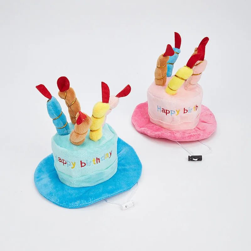 Blue and pink soft birthday hat for small dog on white background.
