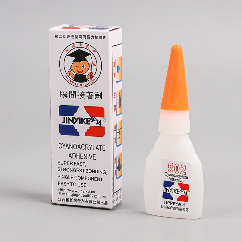 Tube of instant strong adhesive glue for shoe and leather repair with applicator tip.
