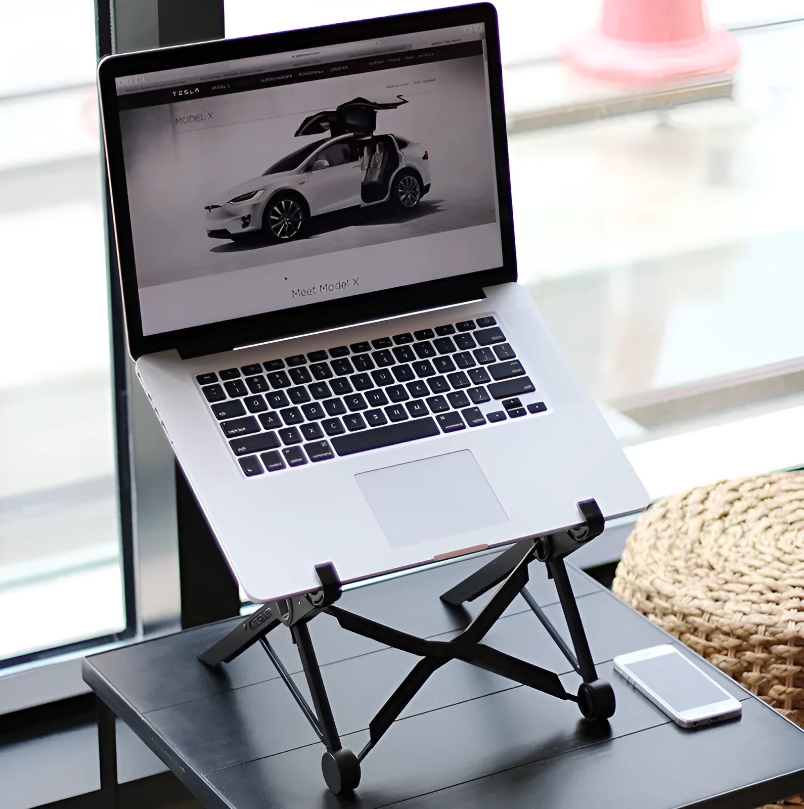 Black folding laptop computer stand with reinforced nylon construction showing folded position at 35.4cm length