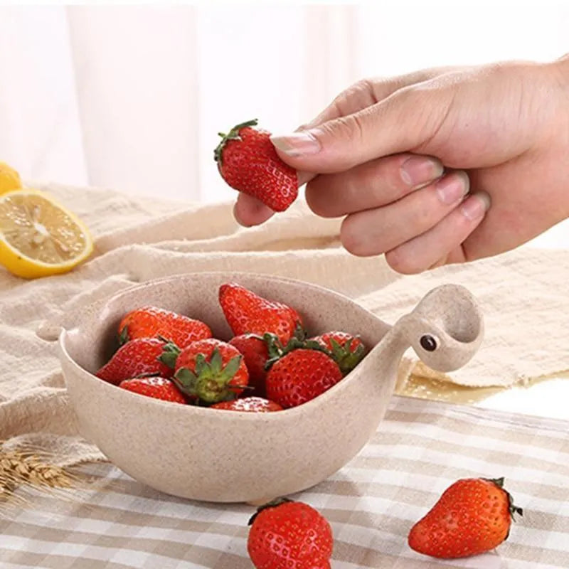 Cute tiny dinosaur bowl made of natural wheat straw fibre in pink, green, and beige colours, lightweight non-slip unbreakable design
