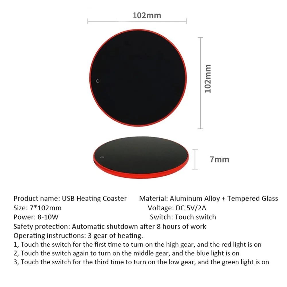 Black USB heating coaster with tempered glass plate on a desk next to a coffee mug