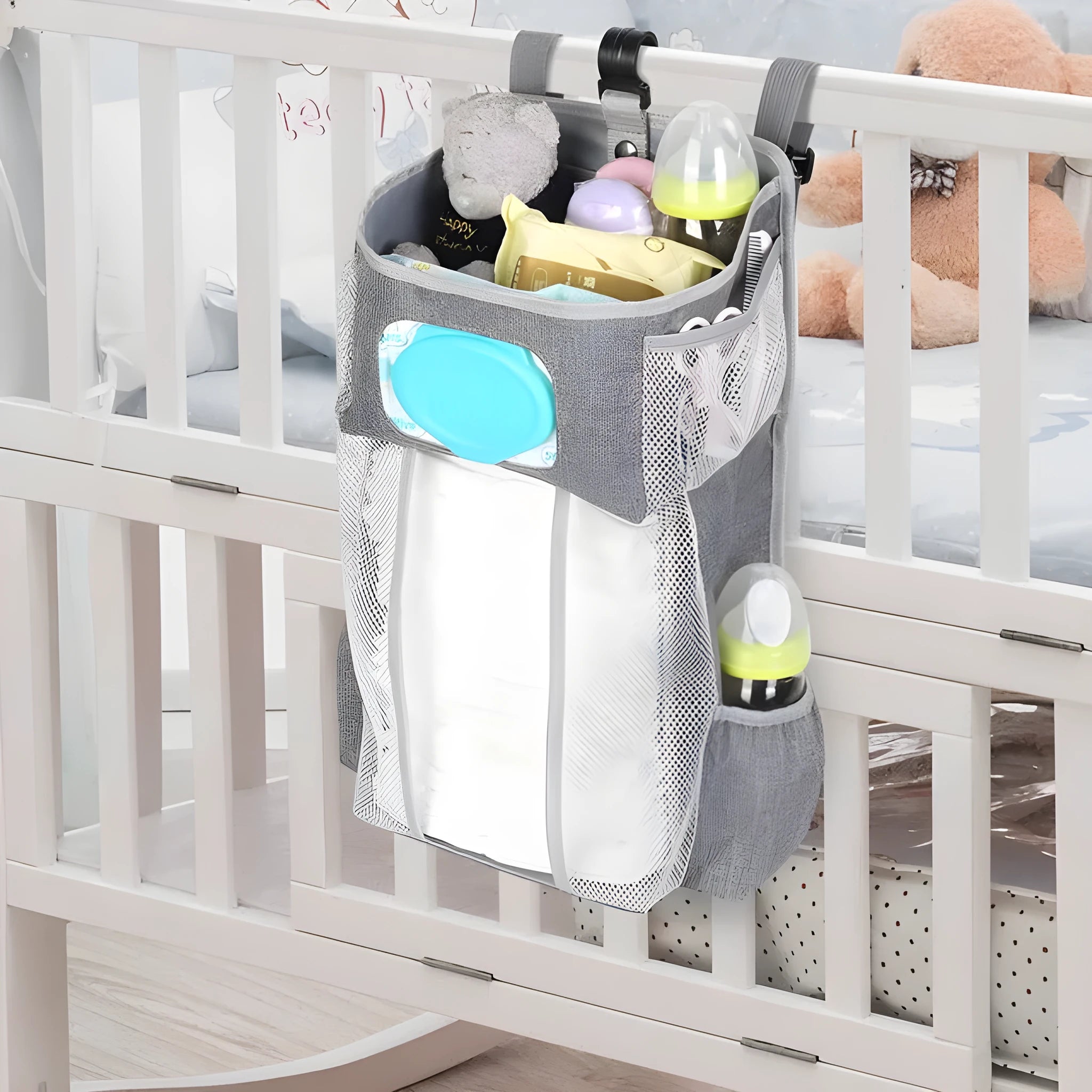 Grey attachable storage bag with diamond mesh panel and PP support plate, 44.6x23x16cm, hung on a white baby cot