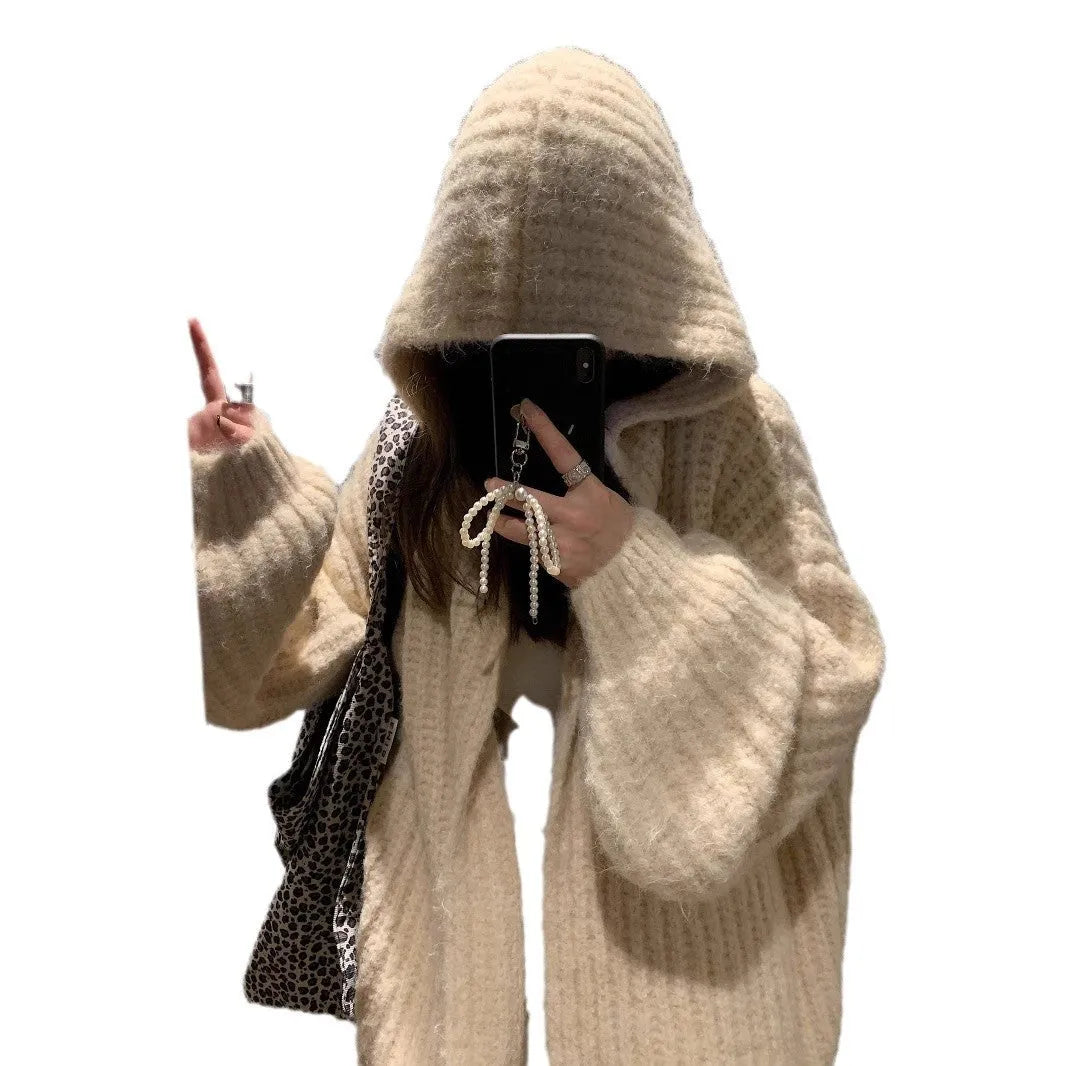 Woman wearing a thick dark grey hooded zip-up cardigan, loose fit.