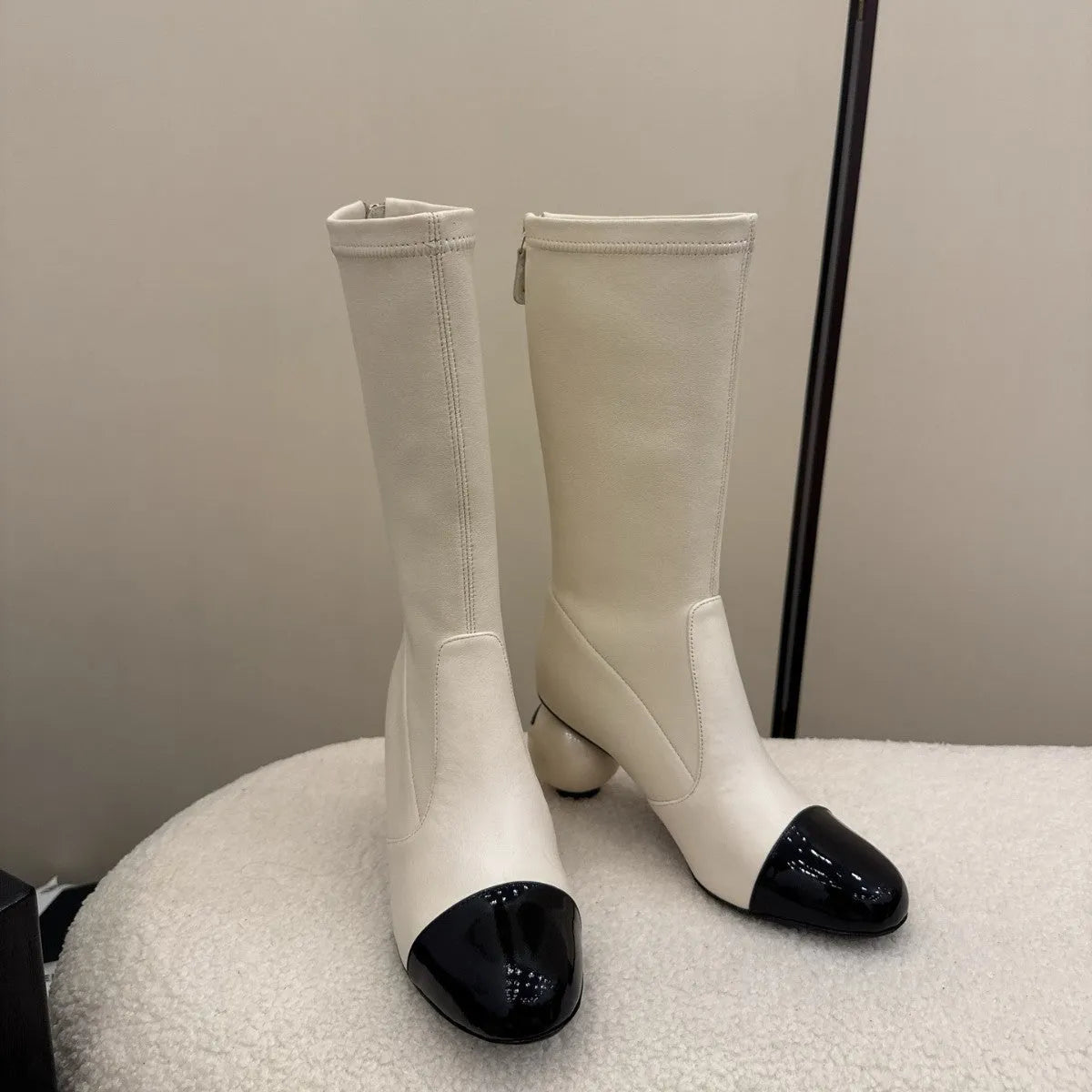 Women's chunky heel ankle boots with elastic fabric upper in black, white, and apricot side view
