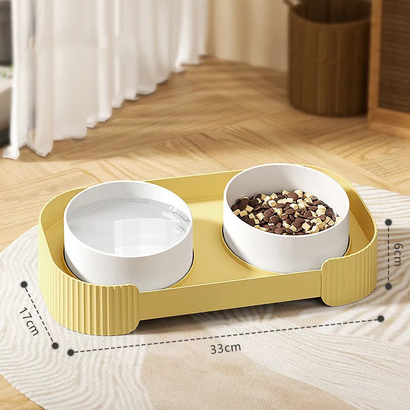 Green ceramic raised cat bowl set with two bowls on a tilted stand, showing non-slip base.