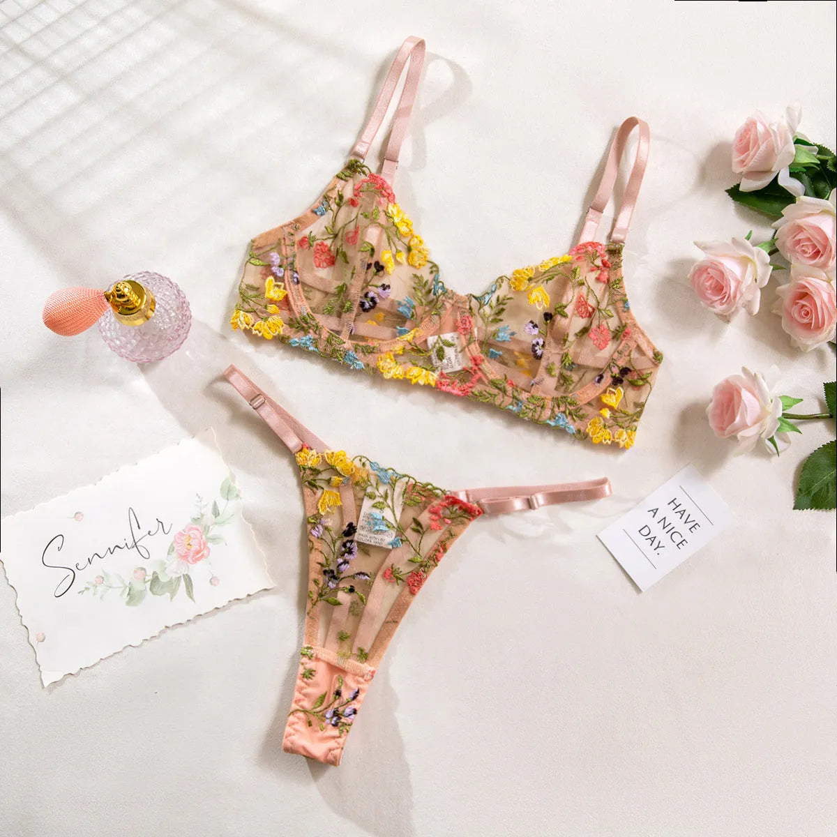 Floral patterned mesh bra with steel ring and matching T-back briefs in a choice of colours.
