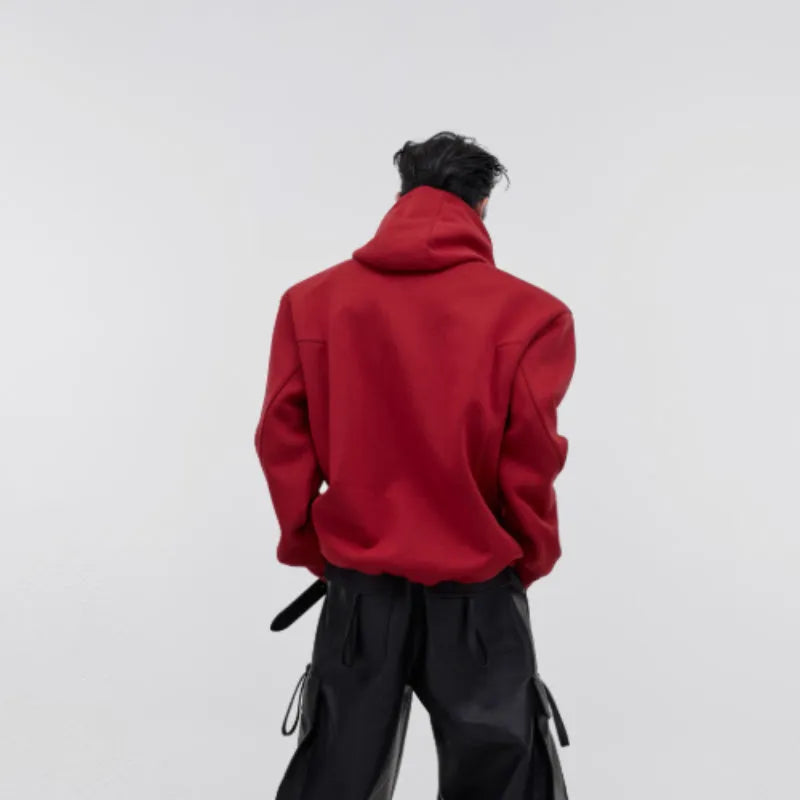 A red men's loose hooded sweater with heavy shoulder pads and a three-dimensional printed pattern.