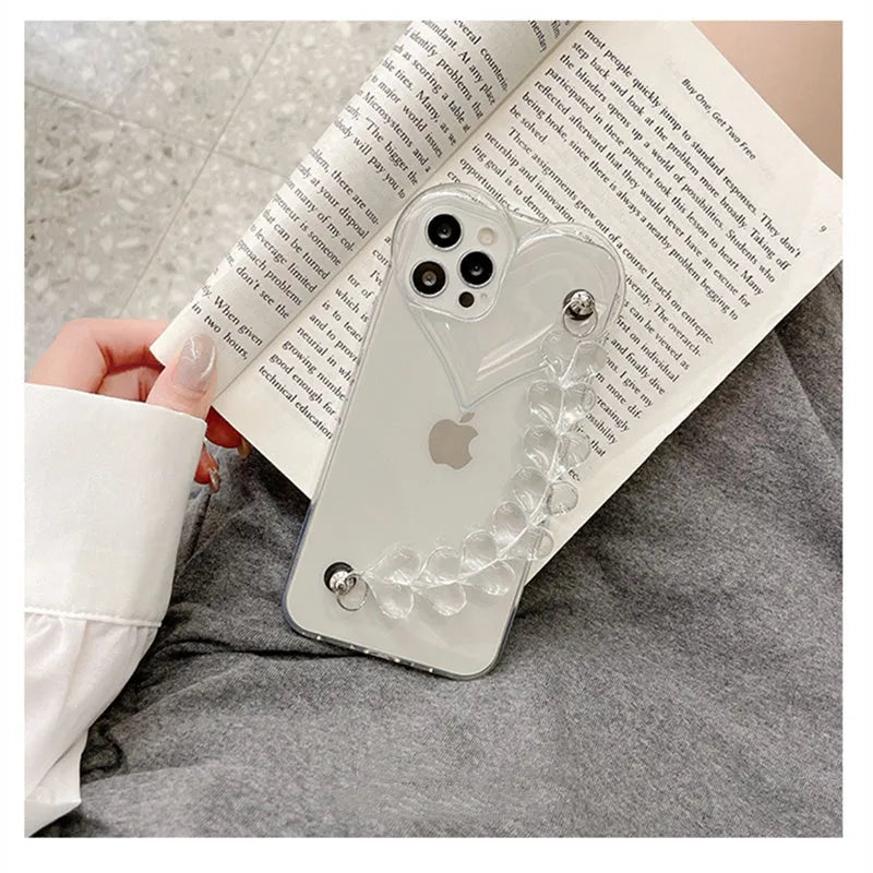 Clear iPhone case with a red love heart and chain design on the back