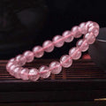 Women's strawberry quartz crystal bracelet with polished beads in 6mm, 8mm, or 10mm diameter options