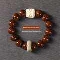 Hand-woven bracelet with 13mm round beads and a carved lion bead centrepiece in ivory nut style.
