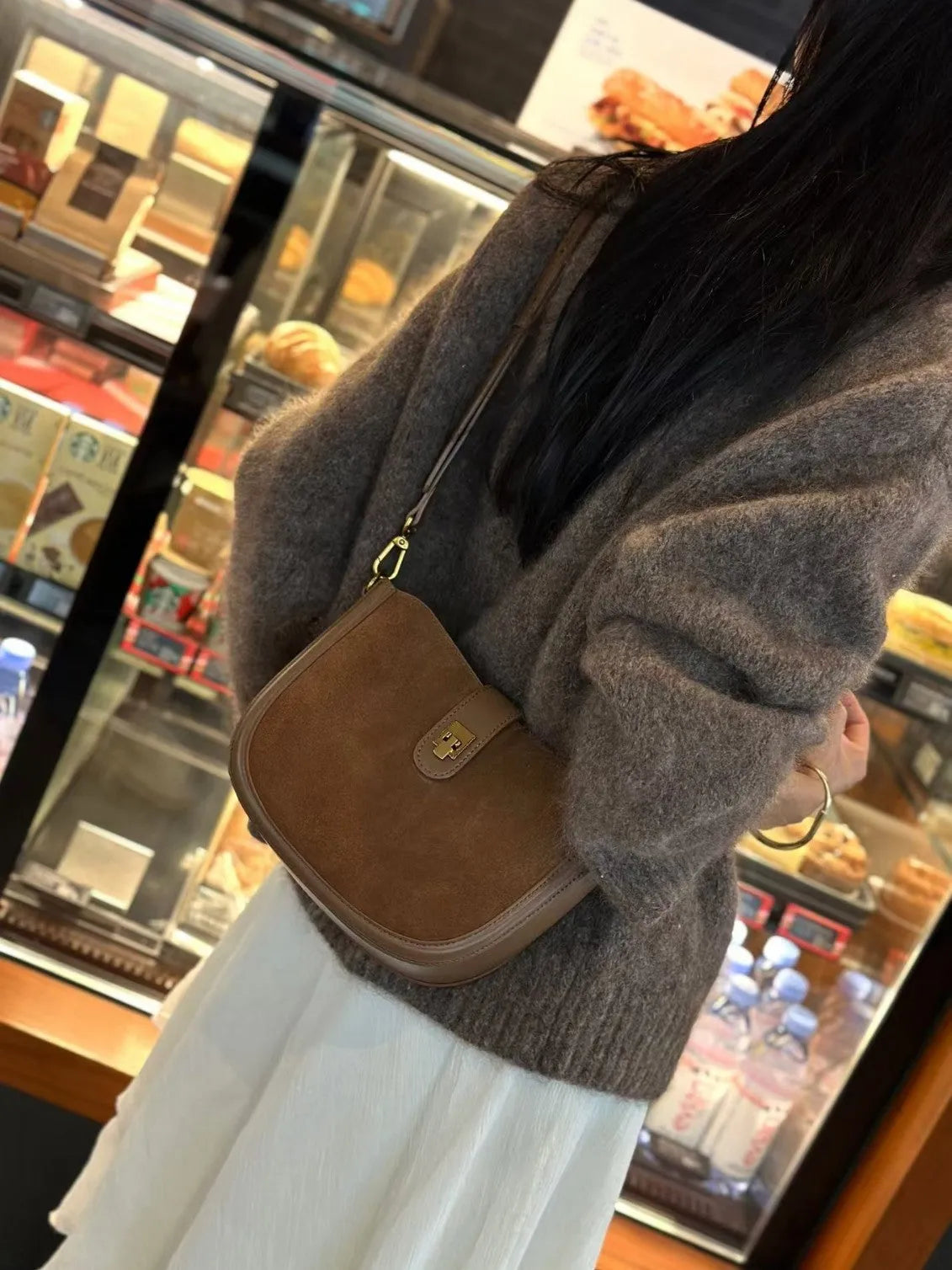 Women's black genuine leather crossbody bag with one-shoulder design and sandwich pocket exterior