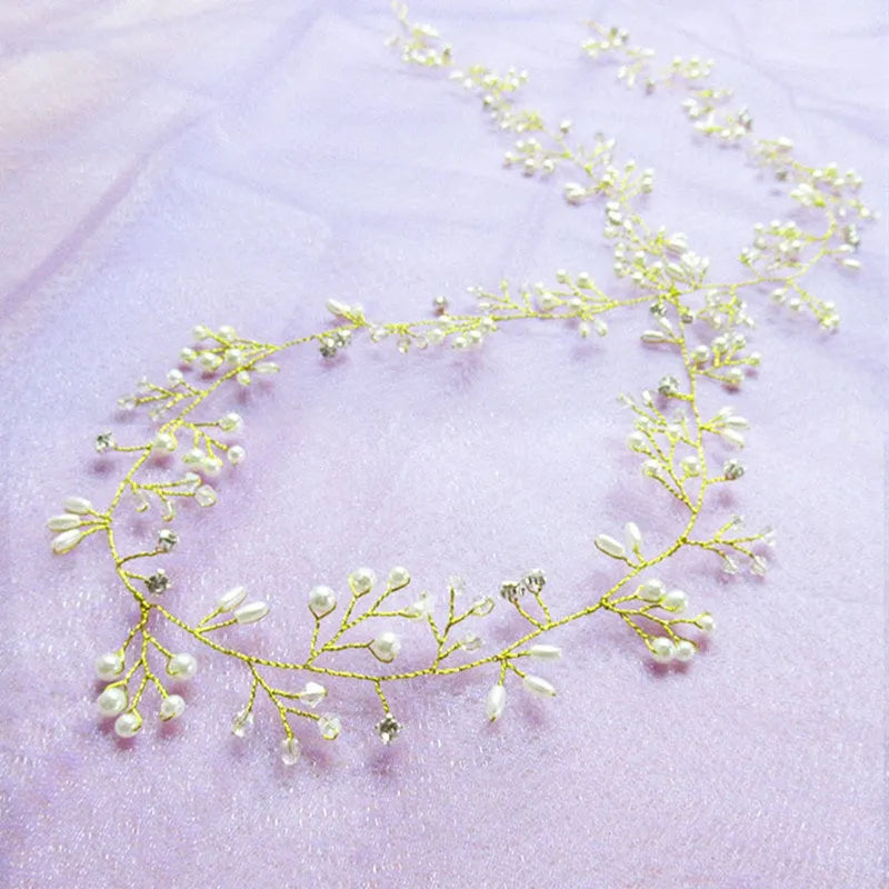 Bridal long hair band with crystals and pearls on a silver wire, shown coiled.