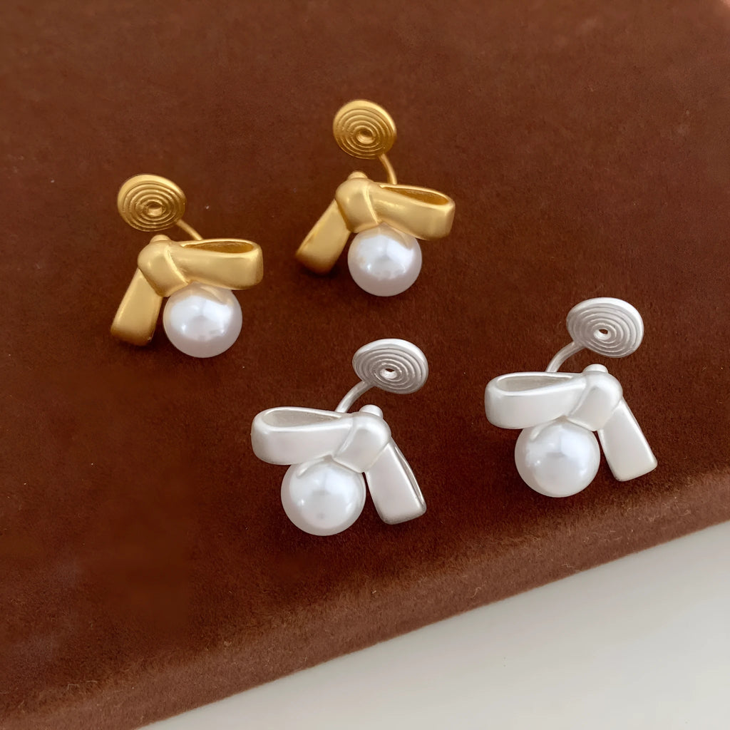 Matte bow earrings for women in matte gold clip-on style on a white background