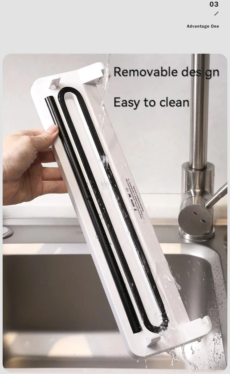 White automatic vacuum sealer machine on a kitchen counter