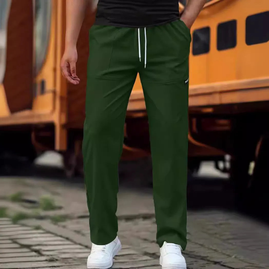 Men's light grey polyester trousers for spring and autumn casual wear, laid flat.