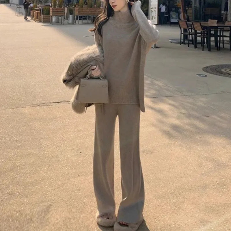 Women's beige acrylic sweater and wide-leg trouser two-piece set laid flat.