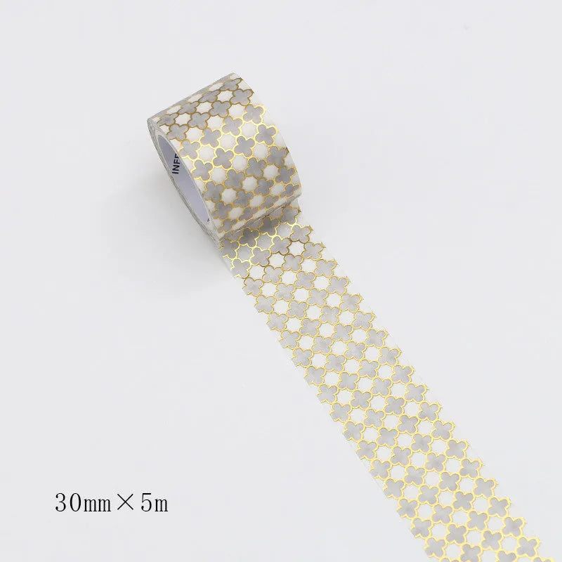 Roll of bronzing and paper decorative tape in gold colour, showing metallic finish.
