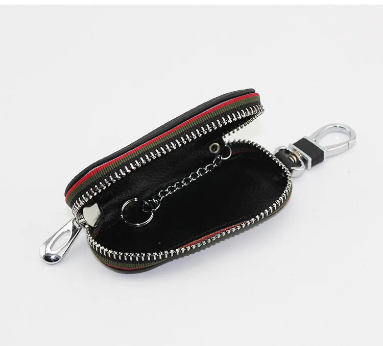 Brown leather car universal key case holding a car key on a white background