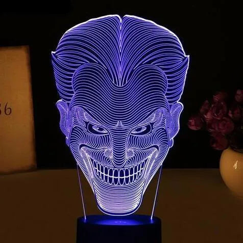 USB-powered 3D LED desk lamp showing multiple colour modes on an acrylic panel with a remote control.