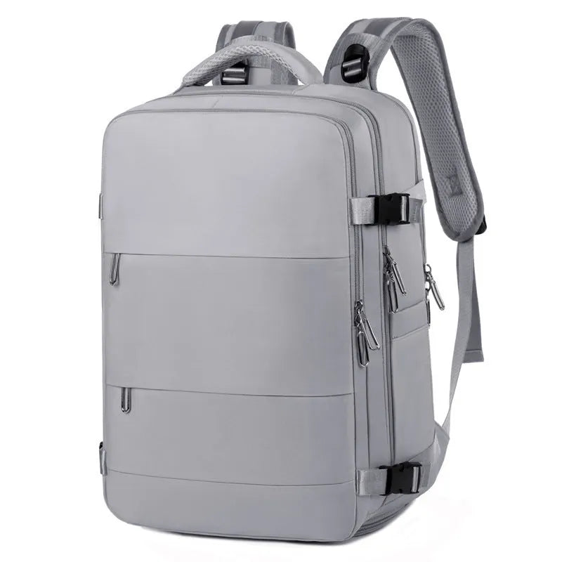 Large purple travel backpack with multiple compartments open, showing laptop sleeve and organiser pockets.