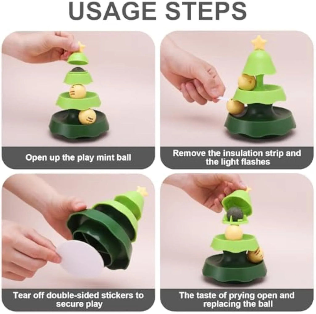 Tree-shaped cat toy track with two tiers of rolling balls and a catnip ball under a green cover on the floor