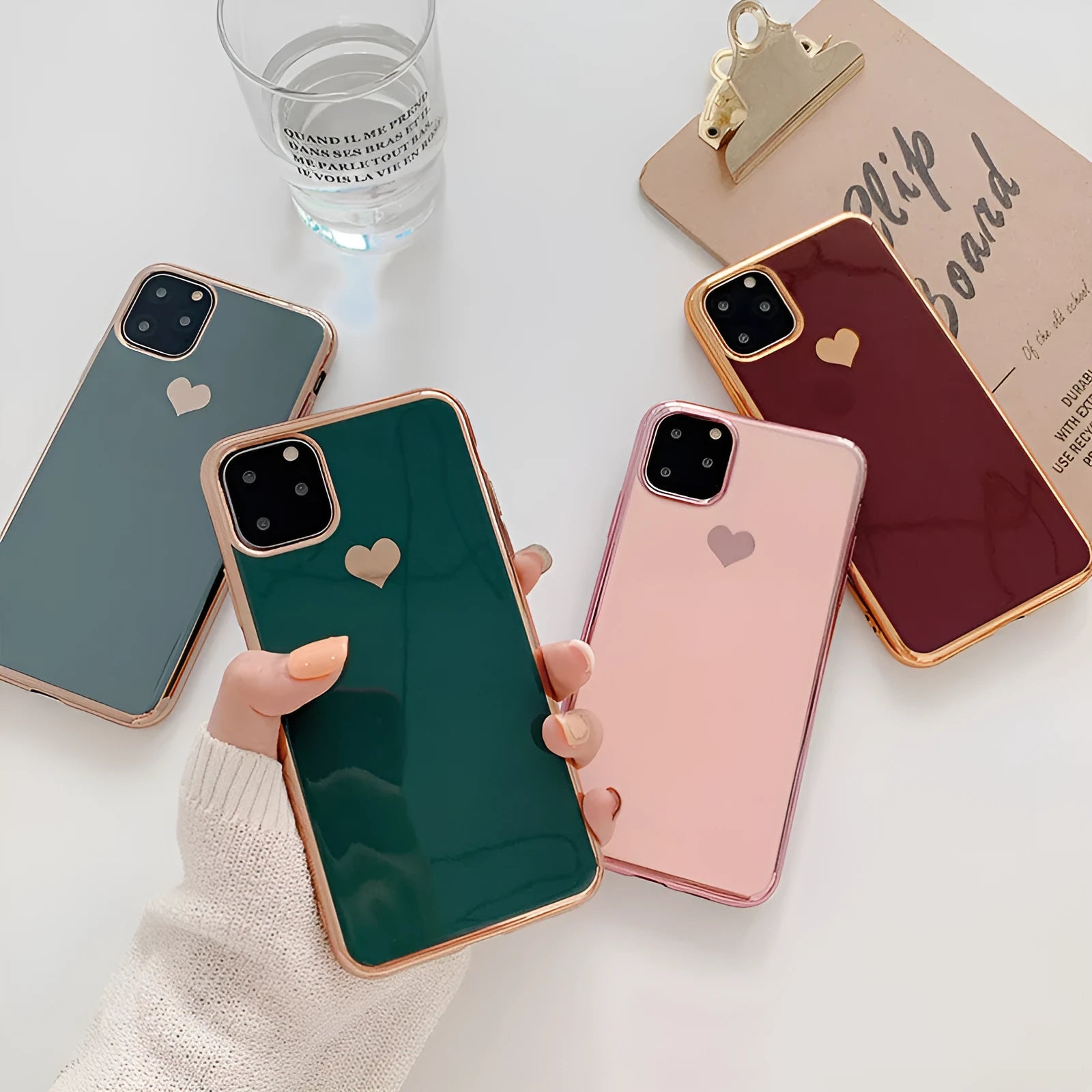 Luxury plating love solid colour TPU back cover case for iPhone on a table.