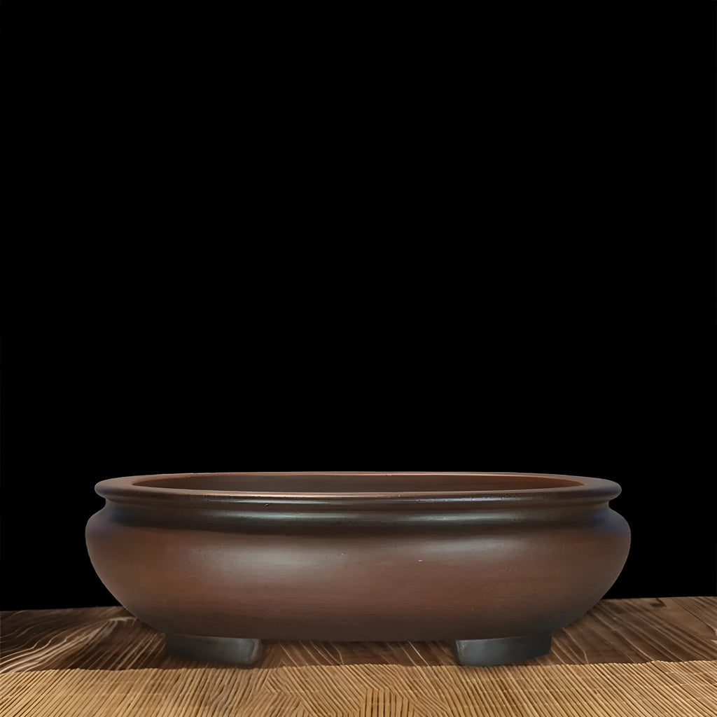 Handmade purple clay classical style desktop flowerpot on a wooden surface