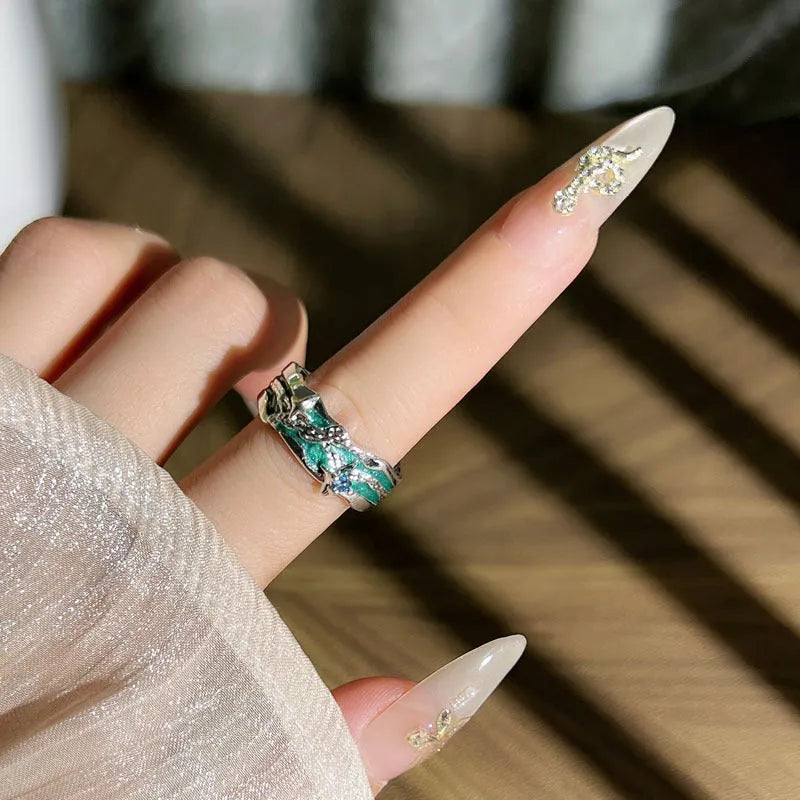 Mint green enamel asterism ring with custom text on copper, showing folding and asymmetric details.