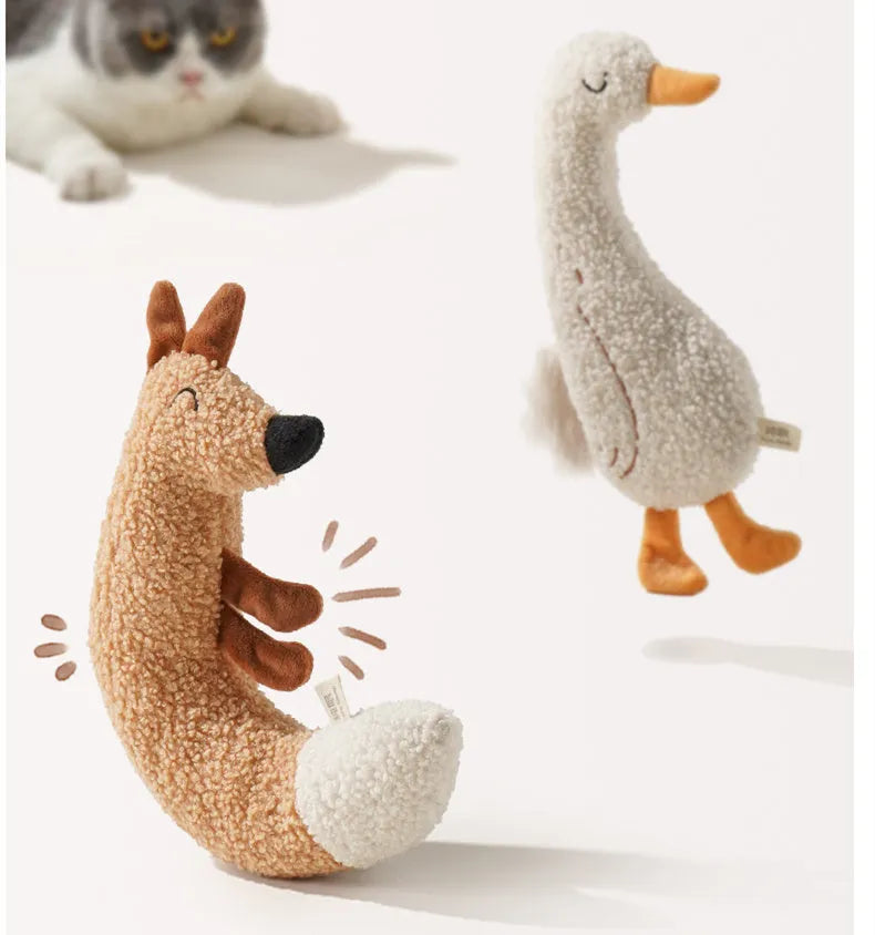 Red fox-shaped and yellow duckling-shaped plush dog toys on a plain background.