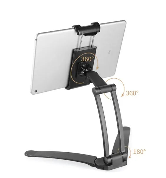 Silver aluminum desktop tablet stand holding a tablet, showing its adjustable clips and 360-degree rotation.