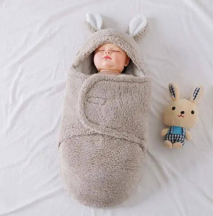 Baby wearing soft fleece sleeping bag with head support and velcro closures