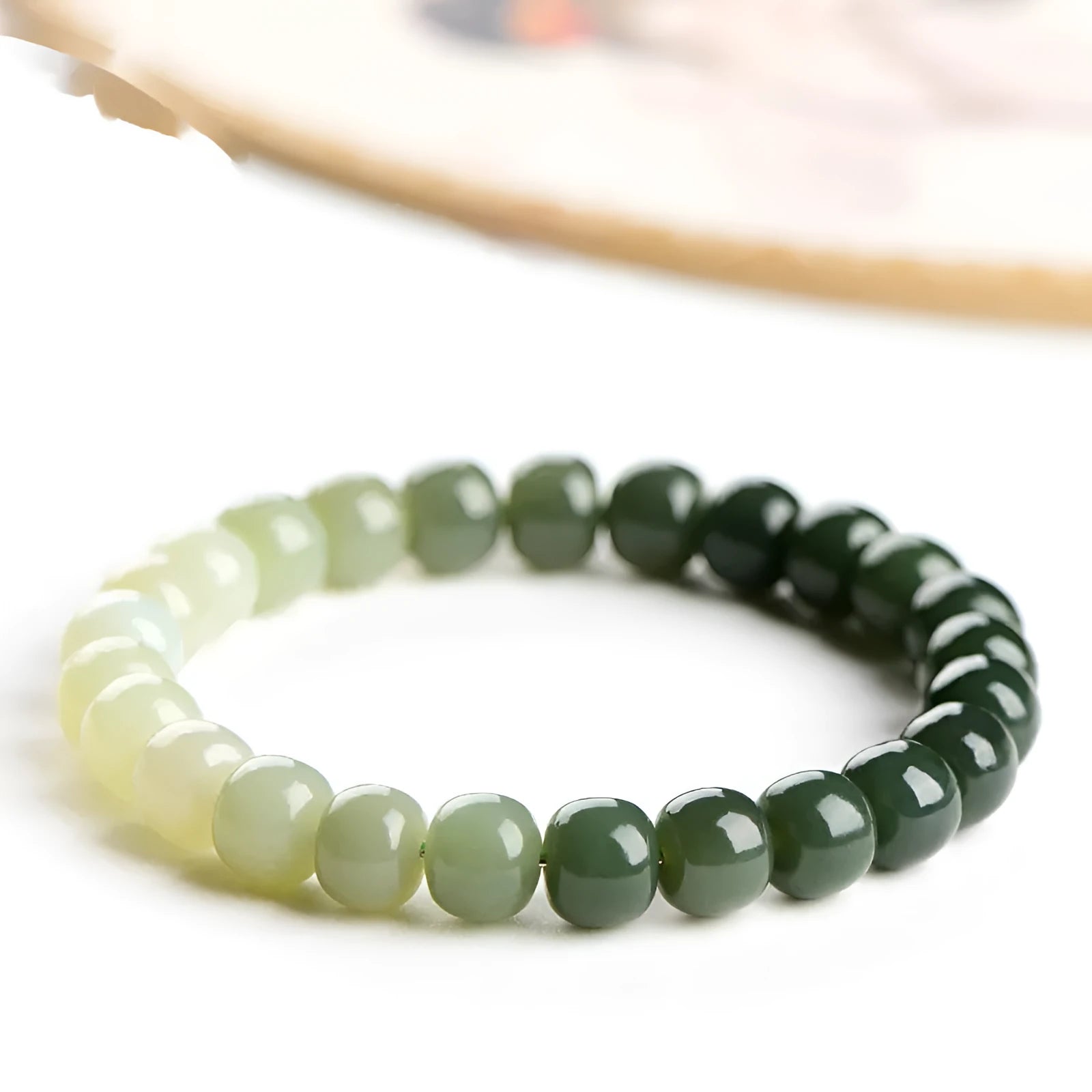 Natural Hetian jade bracelet with gradient clear water colours on wrist.