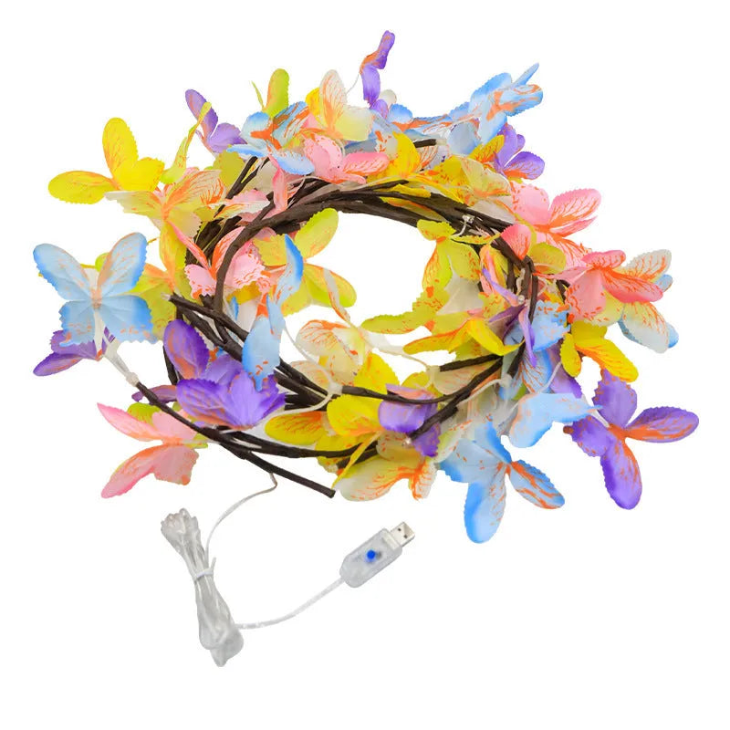 Flexible LED butterfly tree rattan lamp shaped into a decorative spiral, showing USB cable and lit white LEDs.