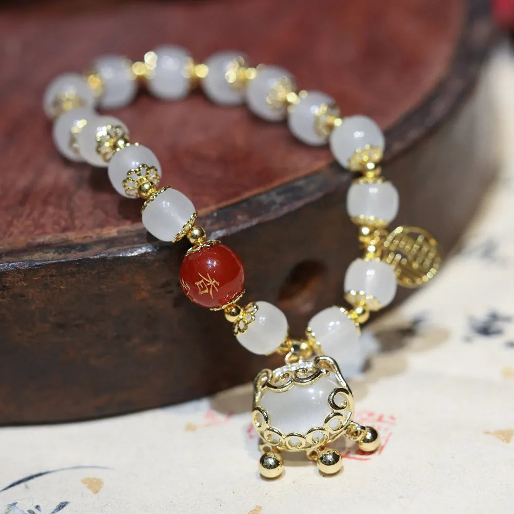 Women's Chinese style glass bracelet with safety lock, fu character, windmill, bamboo, and jade charm elements