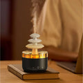 White cloud rain ultrasonic humidifier and essential oil diffuser with colourful LED lights on desk