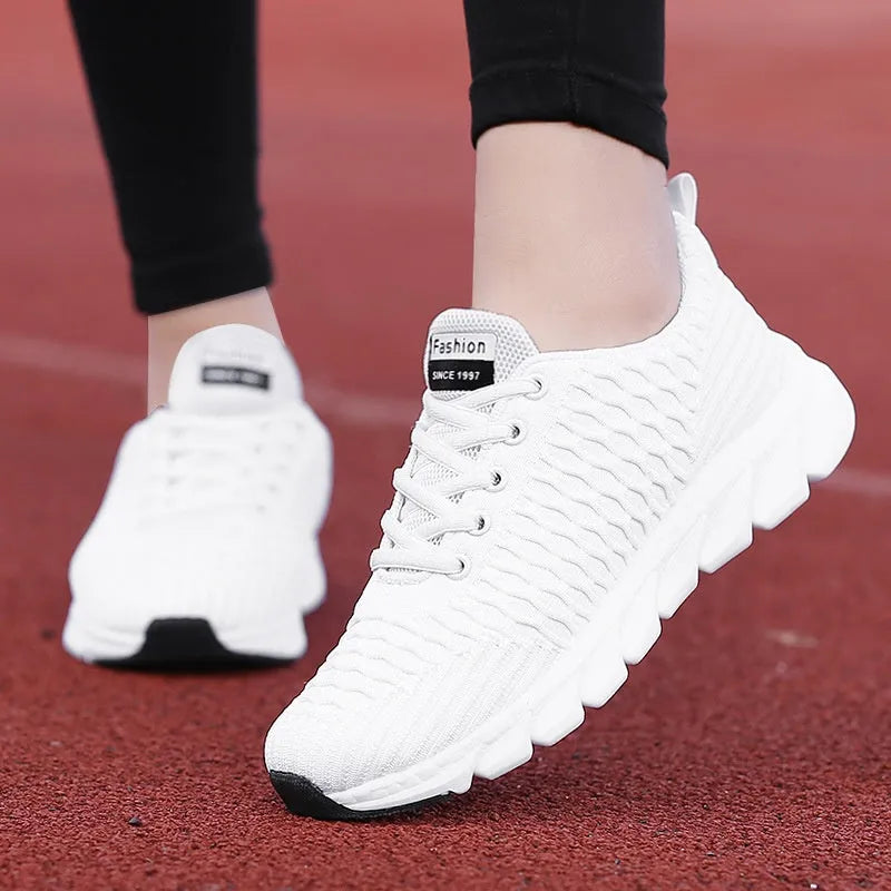 Women's running shoes in black, pink, or white with fly weave upper and durable outsole.
