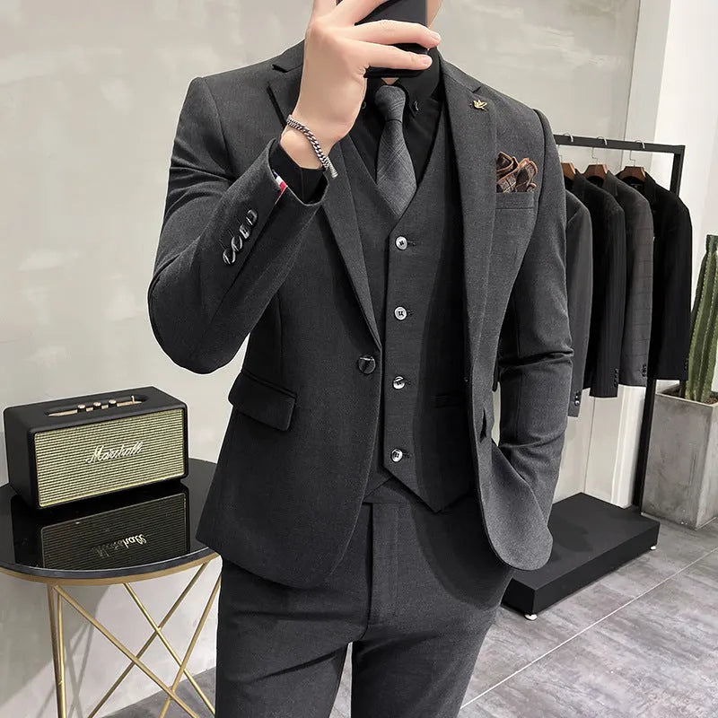 Three-piece men's acetate fibre blend business suit set in light gray with jacket, trousers, and vest.